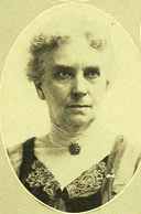 B&W oval portrait photo of a gray-haired women.