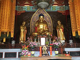 Buddha image, with images of two disciples at the sides.