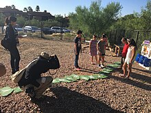 Students being photographed as they demonstrate new playground.