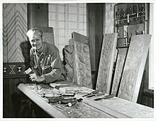 Image of man carving wood