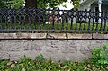 Iron fence and stone retaining wall