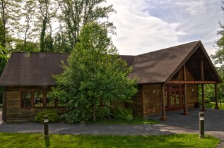 A wooden one-story porticoed building