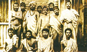 Group photo of Indian young men. Some are sitting, some are standing.