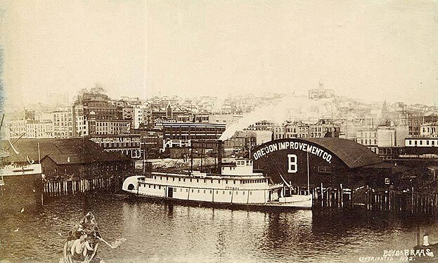 This 1892 photo (which looks a bit retouched; date given by University of Washington Libraries) shows a sidewheeler at Pier B. Presumably the pier partly visible at left is Pier A. Written on Pier B pier shed: "Oregon Improvement Co. B". There's a pointed tower building (maybe the Lebanon Hotel?) in the background at right that is not in the photo with the T.J. Potter, so we know this is later than that.