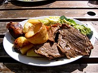 An English Sunday roast with roast beef, roast potatoes, vegetables and Yorkshire pudding