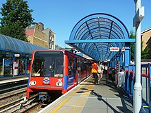Red Docklands Light Railway train at a station