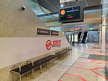 Art seats at CCL platforms beside a staircase. Above the seats, a passenger information screen showed that a CCL train bound for HarbourFront station departing in 1 minute.