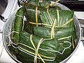 Nacatamales tied up in plantain leaves ready to be steamed.