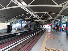 A platform area in a bright new railway station.