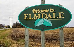sign reading "Welcome to Elmdale" illustrated with two large elm leaves