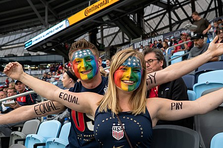 Fans painted with Equal Pay and rainbow flags