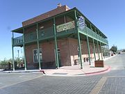 The Silver King Hotel was built in 1876 and is located in 24 W. 6th St. The building was an L-shaped adobe building with a gable roof and walls that were not plastered. The hotel was built for William Long, a partner in the Silver King Mine. Listed as Historic by the Historic District Advisory Commission.