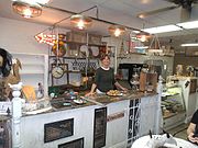 Inside Coyotes Oaties location which once housed the Historic Filers Bakery (founded in 1939) (GAHS), founded in 1939. Posing is co-owner Annette.