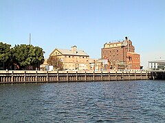 Hart's Mill (1855, centre) and the Adelaide Milling Company flour mill (c.1890, right) are prominent landmarks adjacent to the southern wharf of the Inner Harbour at Port Adelaide. 34°50′33.2″S 138°29′58.4″E﻿ / ﻿34.842556°S 138.499556°E﻿ / -34.842556; 138.499556