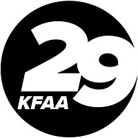 A black circle containing a cut out italicized bold sans serif numeral 29, the 2 above and to the left of the 9. Beneath the 2 are the letters K F A A, smaller but in the same typeface.