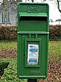 Irish Green postbox at Adare, County Limerick, with the P⁊Ꞇ (P&T) logo