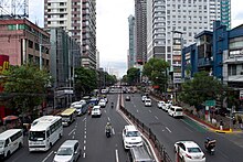 View of the España Boulevard in Manila, looking towards northeast. The boulevard has 8 lanes and also has anti-jaywalking barriers along its entire length (except for at-grade pedestrian crossings and some intersections)