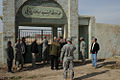 The restoration team gathers at the gateway of the cemetery containing the shrine