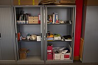 Stationery cupboard: An office stationery cupboard, with its lockable doors open