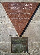 Triangle of pink stone with dark bronze square of text