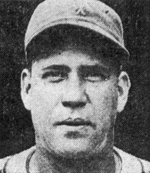 A man in a baseball jersey and cap