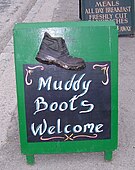 Sign in English saying "Muddy Boots Welcome"