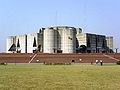 Image 52Jatiyo Sangsad Bhaban is the National Assembly Building of Bangladesh, located in the capital Dhaka. It was created by architect Louis I. Kahn and is one of the largest legislative complexes in the world. It houses all parliamentary activities of Bangladesh. Photo Credit: Karl Ernst Roehl