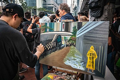 Artist Perry Dino painting the scene