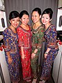 A group of Singapore Airlines flight attendants. The colour of their sarong kebaya represents different ranks.
