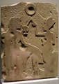 A feminine figure assumed to be Nefertiti, wearing the Kheperesh or "Blue Crown" of a king pours a libation for Akhenaten.