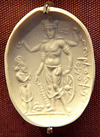 The Vishnu Nicolo Seal may depict Vāsudeva, holding the attributes of the gada club, the chakra discus, the wheel and the lotus, rather than Vishnu. 4th century CE, Gandhara.[note 1]