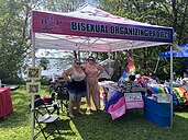 Twp people standing in Bisexual Organizing Project booth standing to pose for the photo