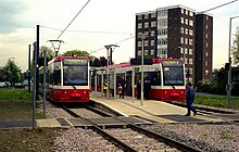 Two low floor trams waiting at a platform