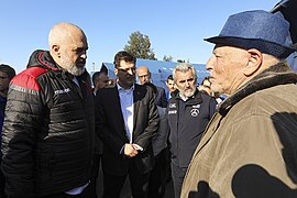 Prime Minister Edi Rama converses with a displaced person