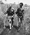 Image 8An Australian soldier, Private George "Dick" Whittington, is aided by Papuan orderly Raphael Oimbari, near Buna on 25 December 1942. (from History of Papua New Guinea)