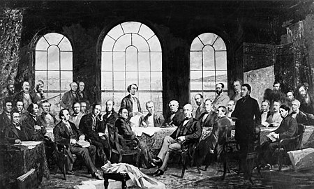 An 1885 photo of Robert Harris' painting, completed the previous year and titled, Conference at Quebec in 1864, to settle the basics of a union of the British North American Provinces, also known as The Fathers of Confederation. The original painting was destroyed in the 1916 Parliament buildings Centre Block fire. The scene is an amalgamation of the Charlottetown and Quebec City conference sites and attendees.