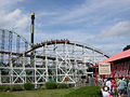 Thunderbolt cresting hill in front of Phantom's Revenge and Pitt Fall