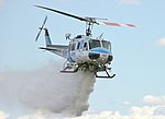 Bell 205 dropping water on fire