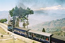 Blue narrow-gauge train at the edge of a drop