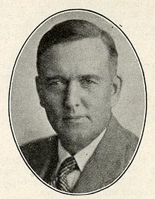 A faded image of a young man in a suit with a striped tie