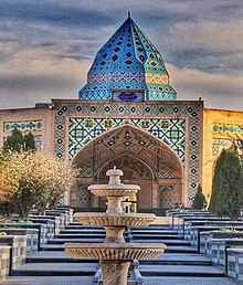 A tomb with a minaret decorated with Persian Blue tiles