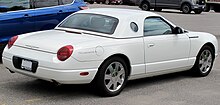 Rear 3/4 view of a white hardtop convertible