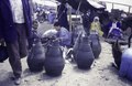 A market with men and women. Waterjars made from old tyres and their maker. Donkeys, 1997