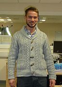 Man wearing shawl collar cardigan and hipster-inspired beard