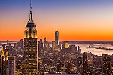 The Empire State Building at sunset looking south. Buildings can be seen in the distance, including One World Trade Center.