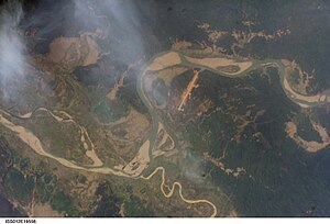 Satellite view. The long strip is Homalin Airport. The meandering Uyu river can be seen joining the Chindwin river south of the town.