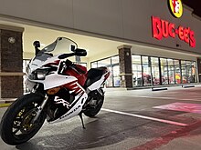 A white 1999 Honda VFR800 outside of Buc-ees