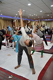 Participants in Trikonasana in the International Day of Yoga, Kolkata, 2015, on cotton sheets