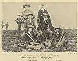 Team photograph of a rifle shooting team, in black and white.