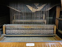 Interior of the organ at Cradley Heath Baptist Church showing the tracker action. The black rods, called rollers, rotate to transmit movement sideways to line up with the pipes.